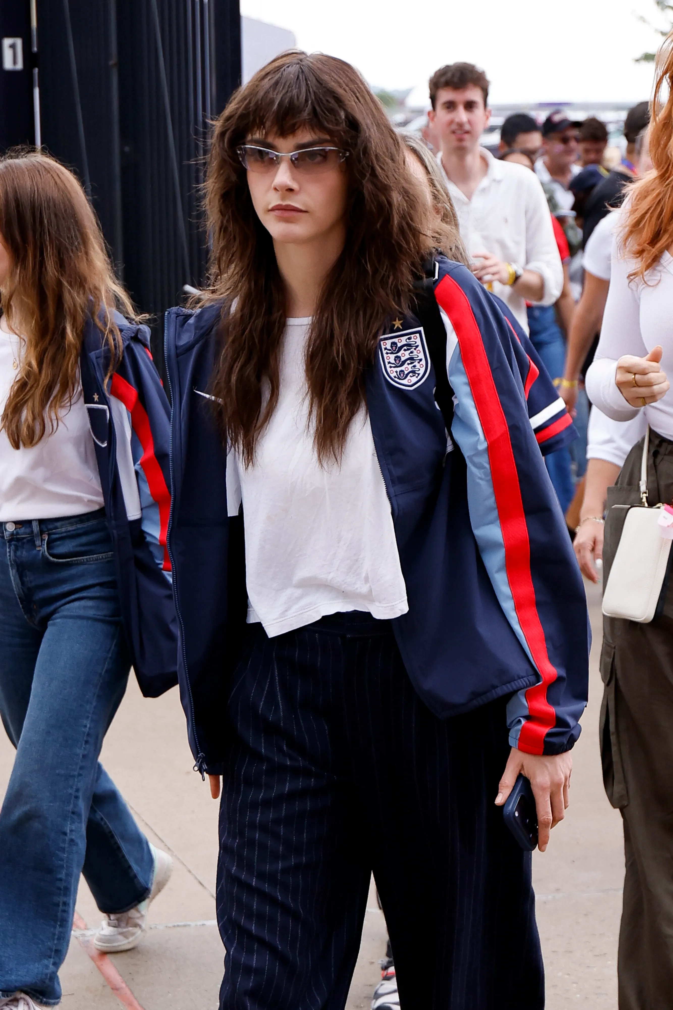 Cara Delevingne wearing an England Three Lions sweatsuit.