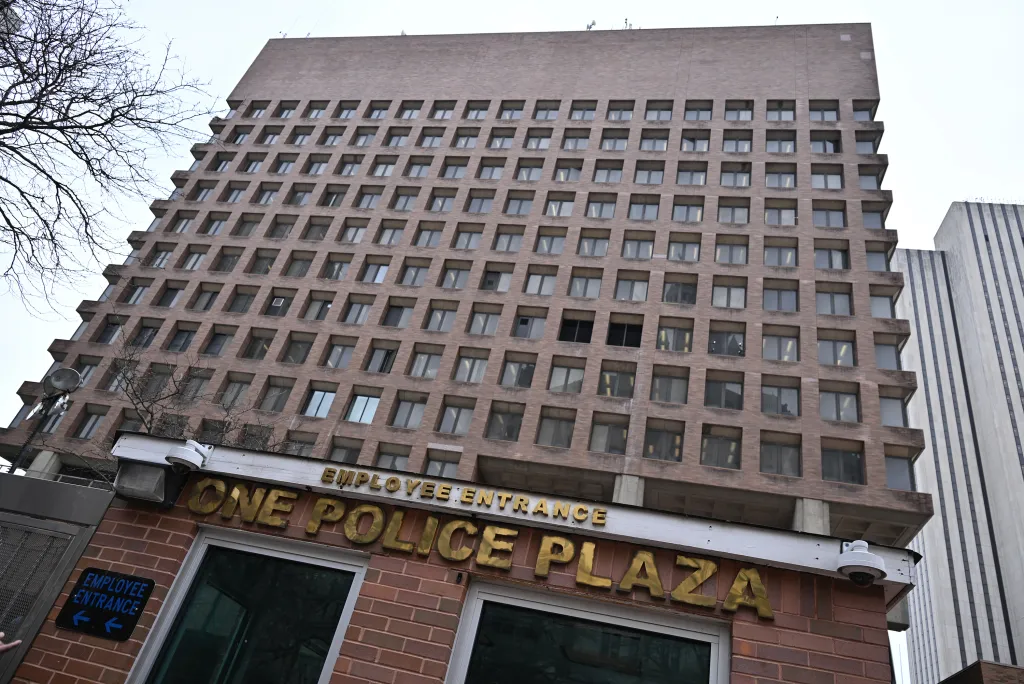 One Police Plaza in lower Manhattan, with the sign "EMPLOYEE ENTRANCE" above.