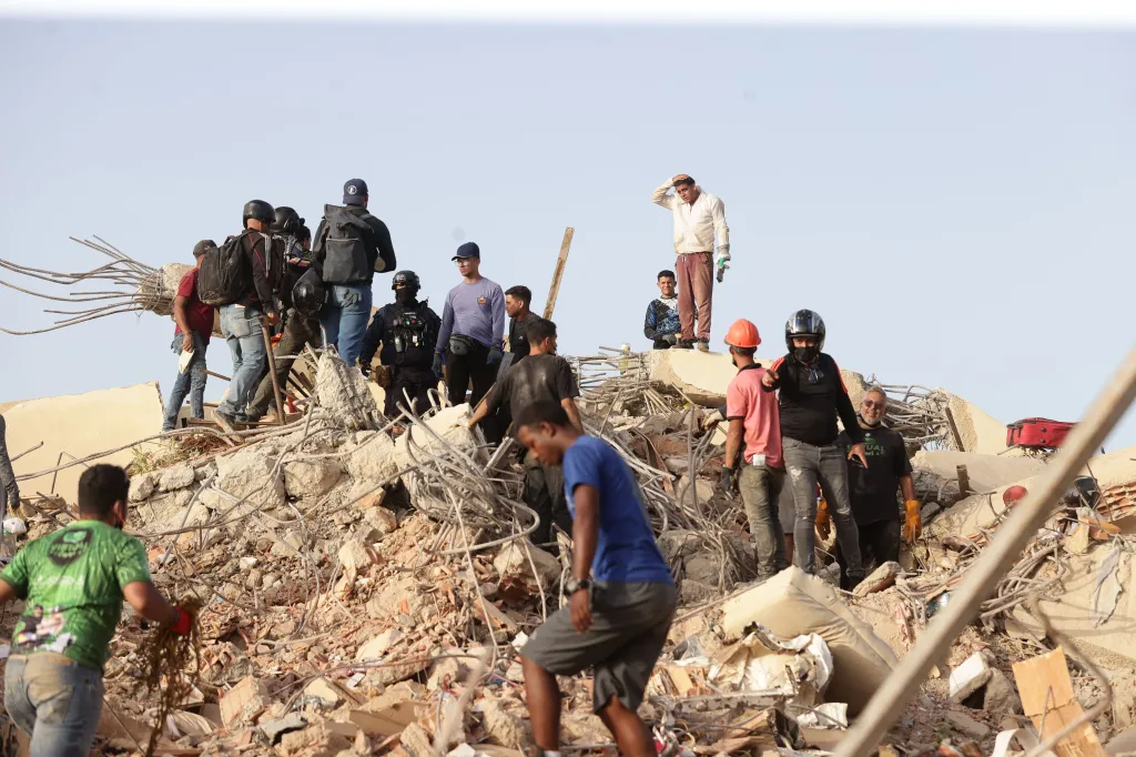 Rescue workers conduct search operations in an area affected by an earthquake in La Guaira, Venezuela.