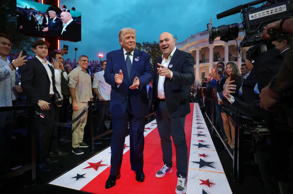 Donald Trump and Dana White walk on a red carpet with stars.