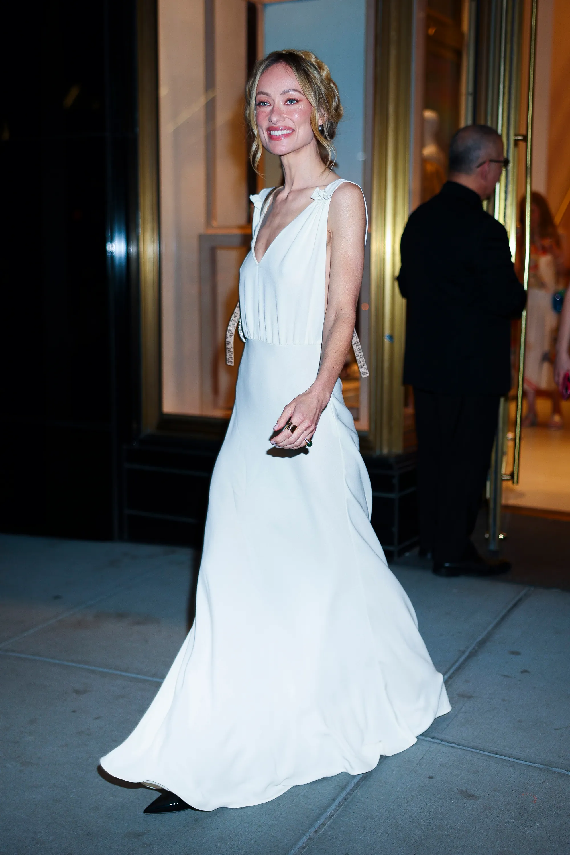 Olivia Wilde in a white dress at the Fendi flagship store.