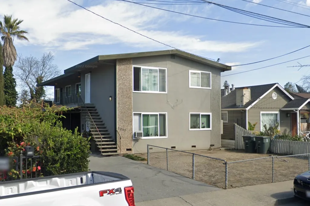 Street view of the exterior of 2857 Marlborough Avenue, a grey two-story building with white-framed windows and an external staircase.