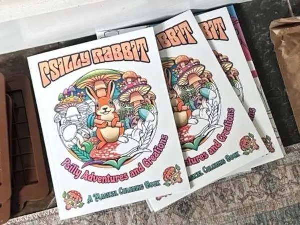 Three coloring books titled "Psilly Rabbit Psilly Adventures and Creations A Magical Coloring Book" feature a rabbit surrounded by mushrooms.