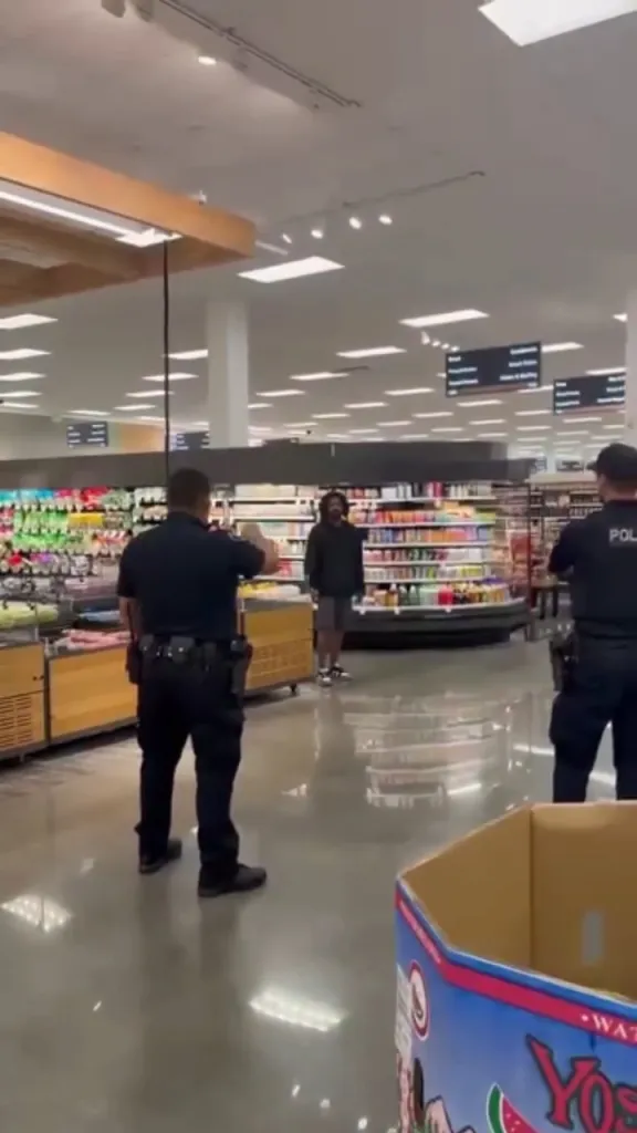Police officers confronting Rejean Tabor inside a Target store.