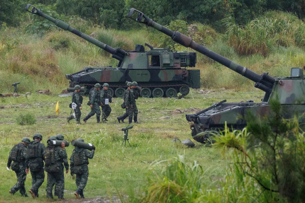 Taiwanese soldiers carry artillery shells for an M109A2 self-propelled howitzer during a live-fire training exercise in Taichung on June 9, 2026.