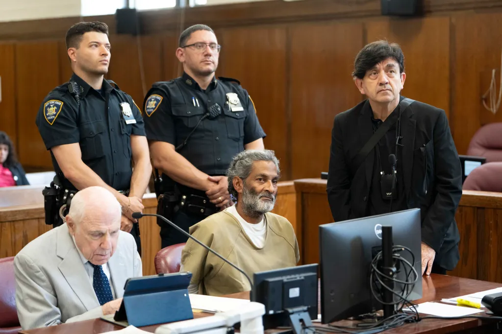 Hector DeLeon, defendant in a courthouse, with court officers, a lawyer, and an interpreter.