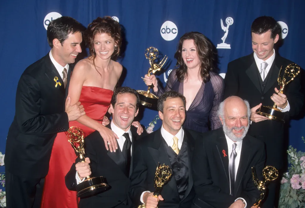 The cast and producers of "Will & Grace" pose with their Emmy Awards, including Eric McCormack, Debra Messing, Megan Mullally, Sean Hayes, Max Mutchnick, David Kohan, and James Burrows.