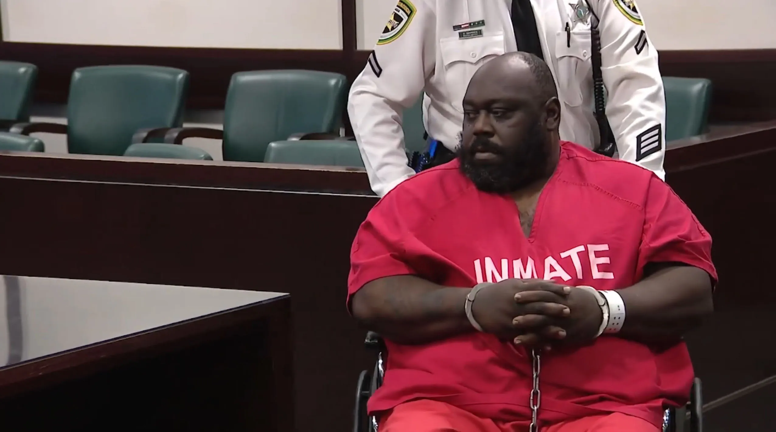 Actor Faizon Love in a red jumpsuit with the word