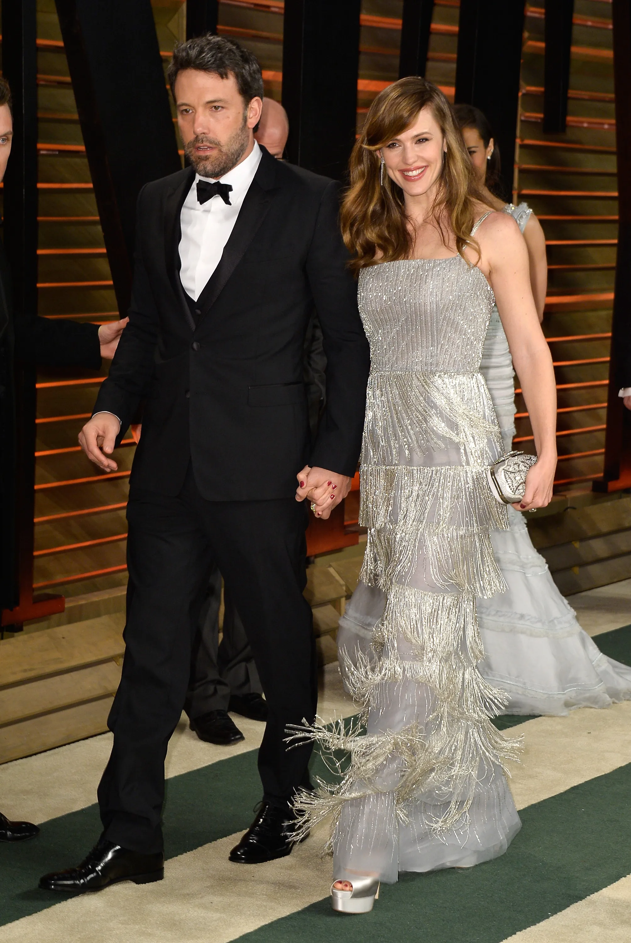 Actors Ben Affleck and Jennifer Garner holding hands.
