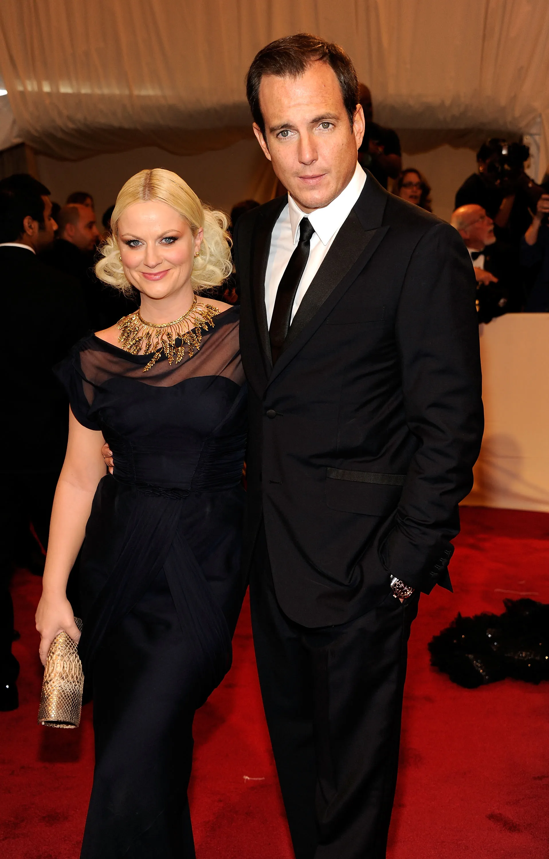Amy Poehler and Will Arnett posing at the "Alexander McQueen: Savage Beauty" Costume Institute Gala.