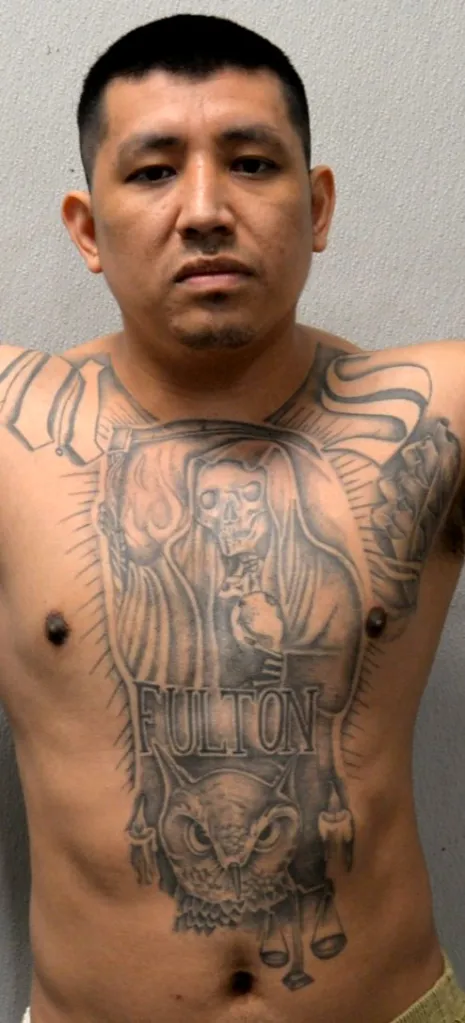 Angel Amadeo Guzman with a chest tattoo of a hooded skeleton, an owl, and "FULTON".