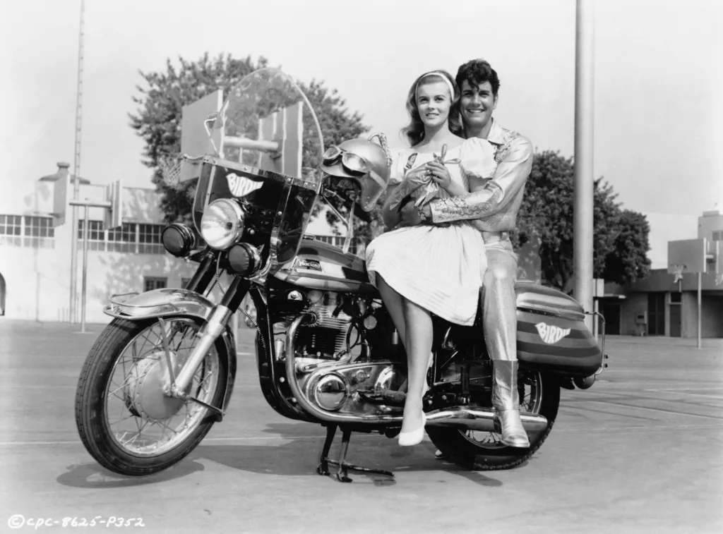 Ann-Margret as Kim McAfee and Jesse Pearson as Conrad Birdie on a motorcycle in a film still from the 1963 film "Bye Bye Birdie".