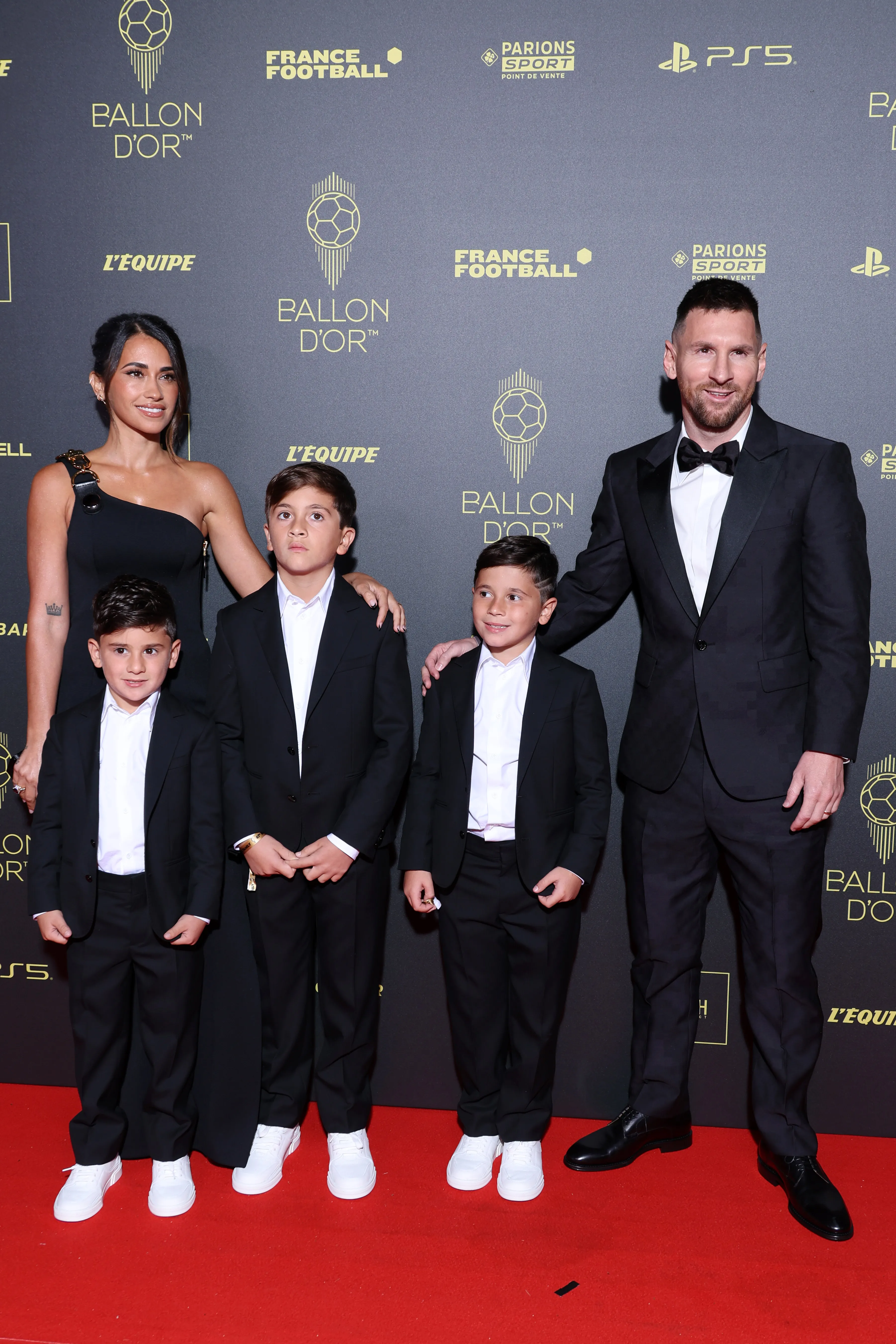 Antonela Roccuzzo and Lionel Messi with their three sons pose together at the 67th Ballon d'Or Photocall.