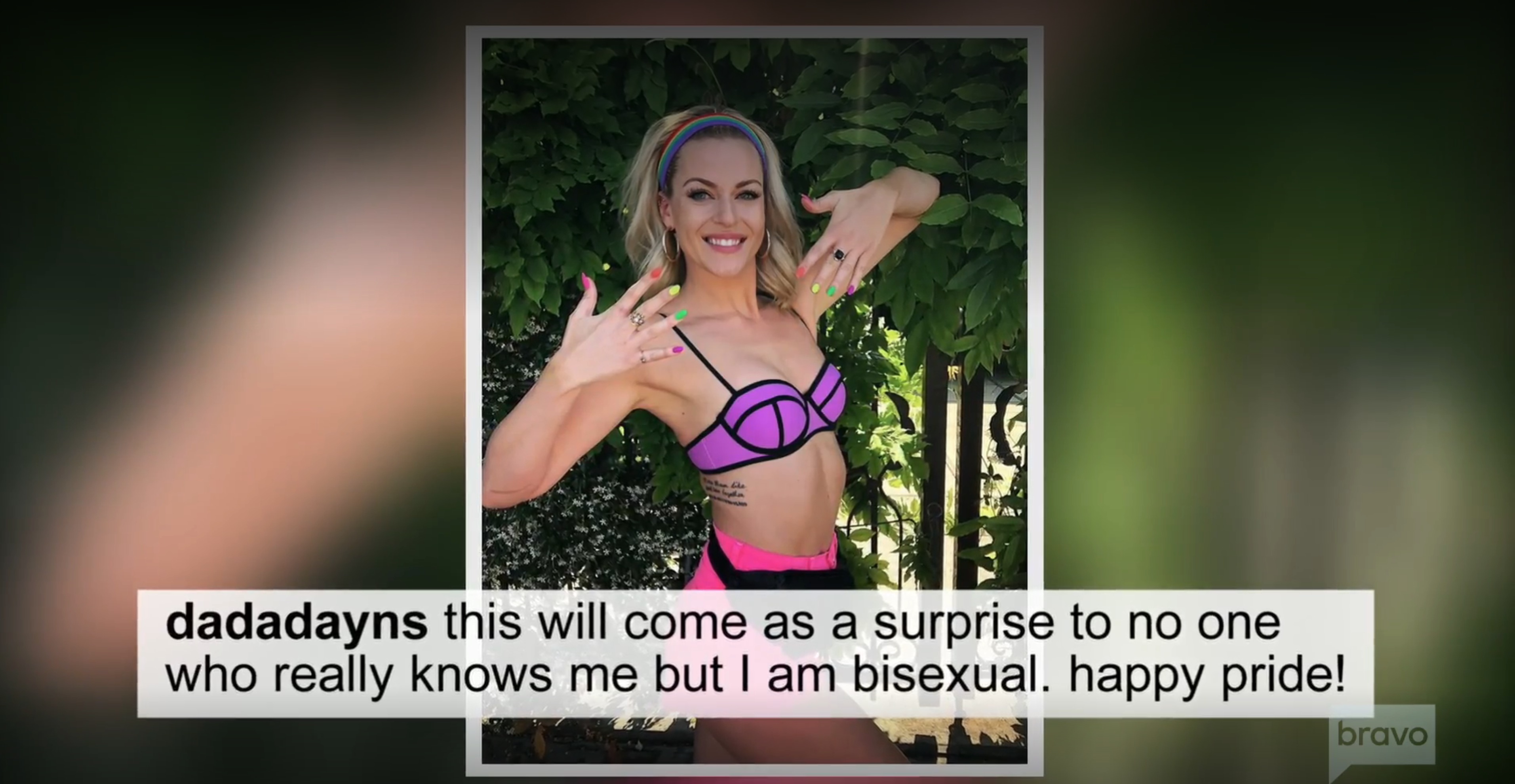 Dayna Kathan in a bikini top and shorts, raising her hands to show off her neon-colored nail polish, with text below her image that reads, "dadadayns this will come as a surprise to no one who really knows me but I am bisexual. happy pride!"