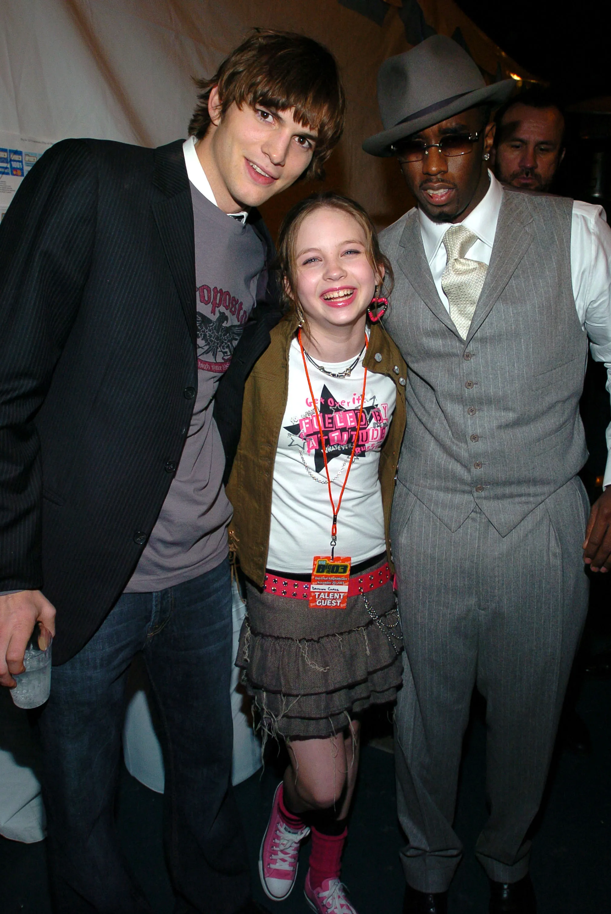 Ashton Kutcher, Daveigh Chase, and Sean "P. Diddy" Combs posing together.