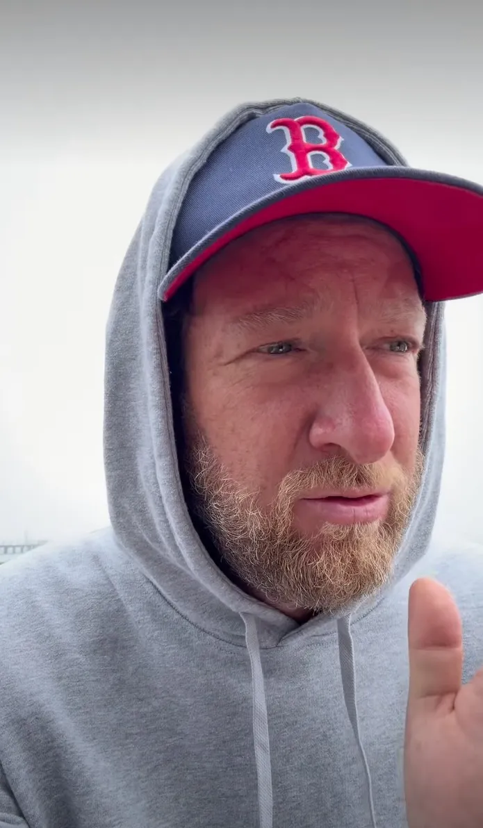 Ave Portnoy in a grey hoodie and a red and blue Boston Red Sox cap.