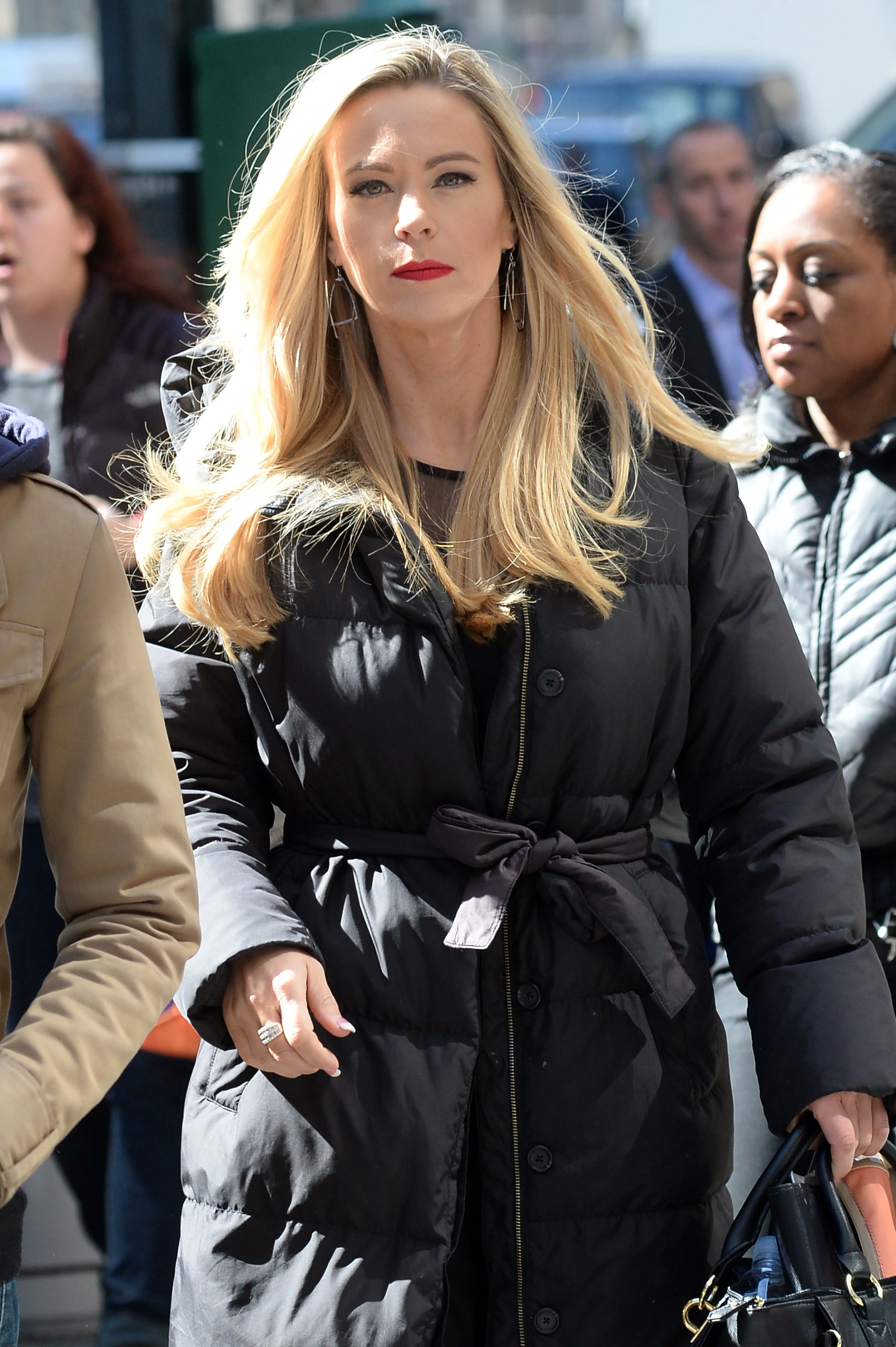 Kate Gosselin wearing a black puffer coat and red lipstick.