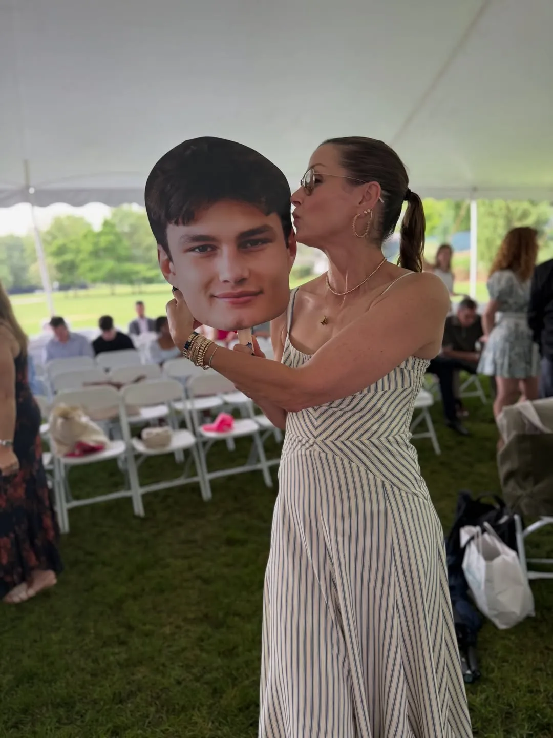 Bridget Moynahan kisses a large cutout of her son Jack's face.