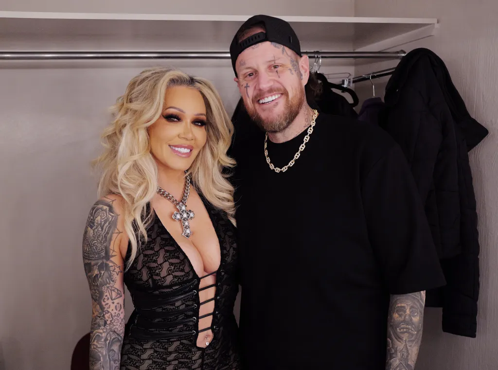 Bunnie XO and Jelly Roll smiling while standing in a closet.