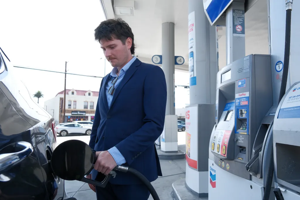 Lennox Morris, 23, pumping gas into his car at a Chevron station in Los Angeles.