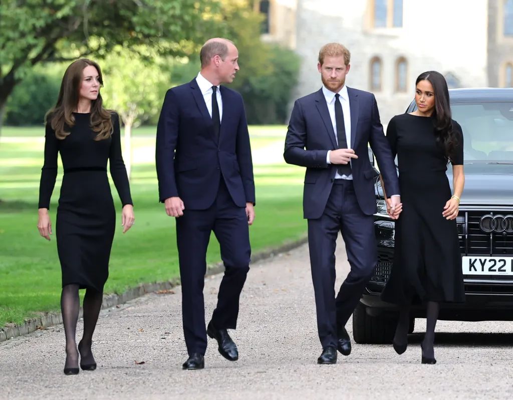 Catherine, Princess of Wales, Prince William, Prince of Wales, Prince Harry, Duke of Sussex, and Meghan, Duchess of Sussex, walk toward well-wishers outside Windsor Castle.