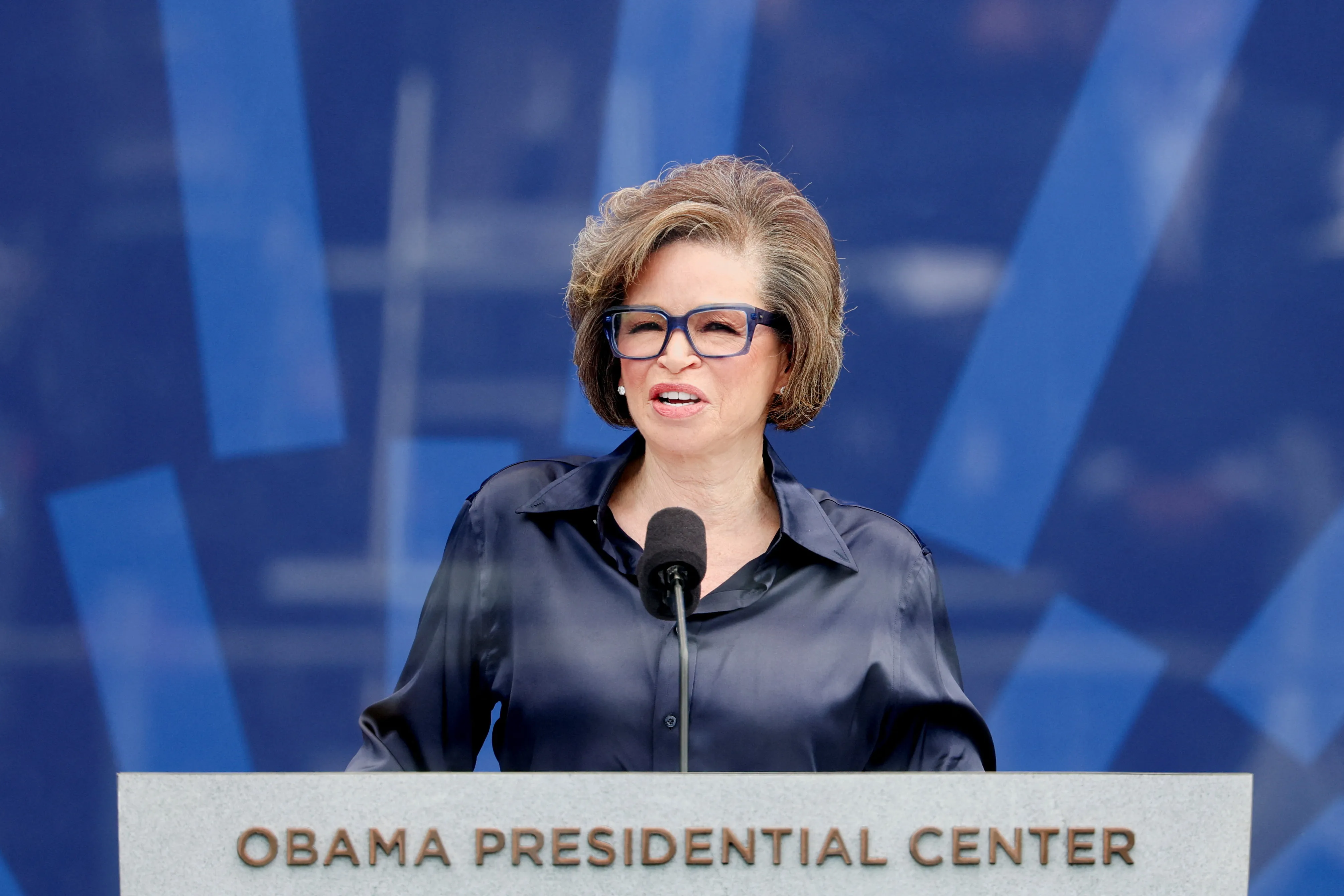 Valerie Jarrett, CEO of The Obama Foundation, speaks at a podium with "OBAMA PRESIDENTIAL CENTER" inscribed on it.
