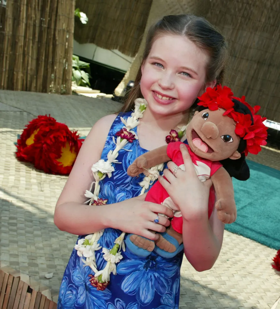 Daveigh Chase, voice of Lilo, holding a Lilo doll at the premiere for "Lilo & Stitch."