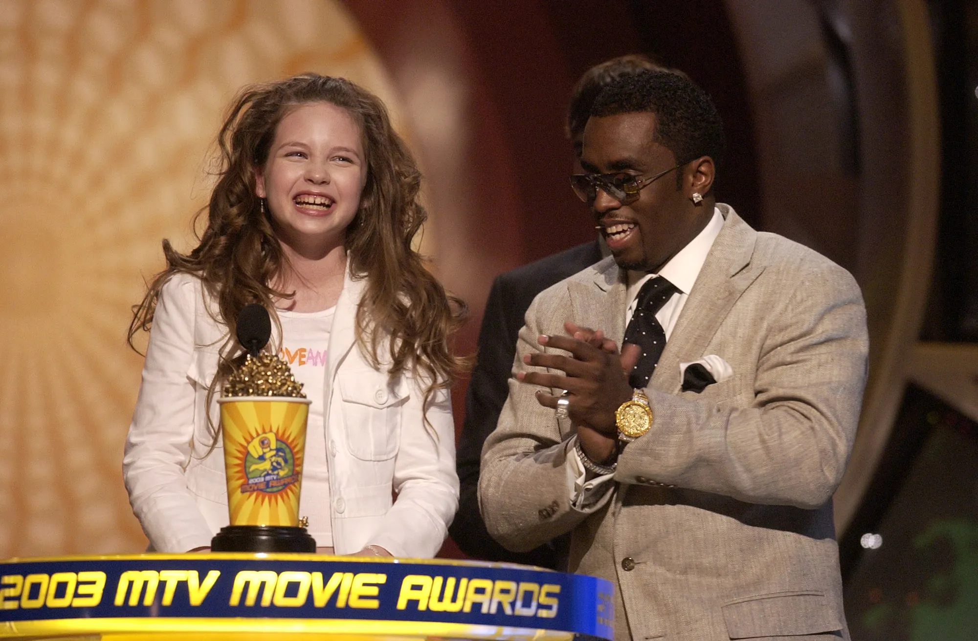 Daveigh Chase and P. Diddy on stage at the 2003 MTV Movie Awards.