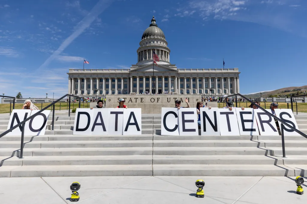 Protesters at the Utah State Capitol hold large signs spelling "NO DATA CENTERS" to oppose the proposed Stratos data center.