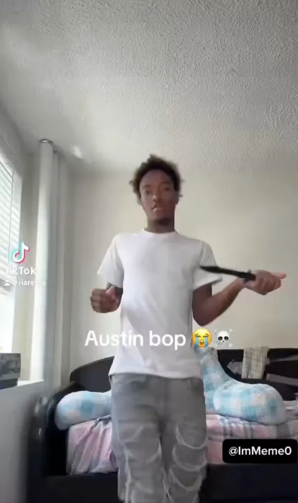 A young man in a white t-shirt and ripped jeans dances while holding a knife, with "Austin bop" and emojis written on the screen.