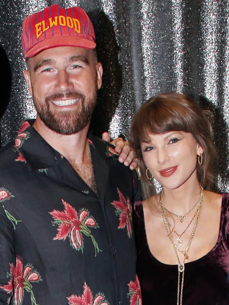 Travis Kelce and Taylor Swift posing backstage at a Broadway show.