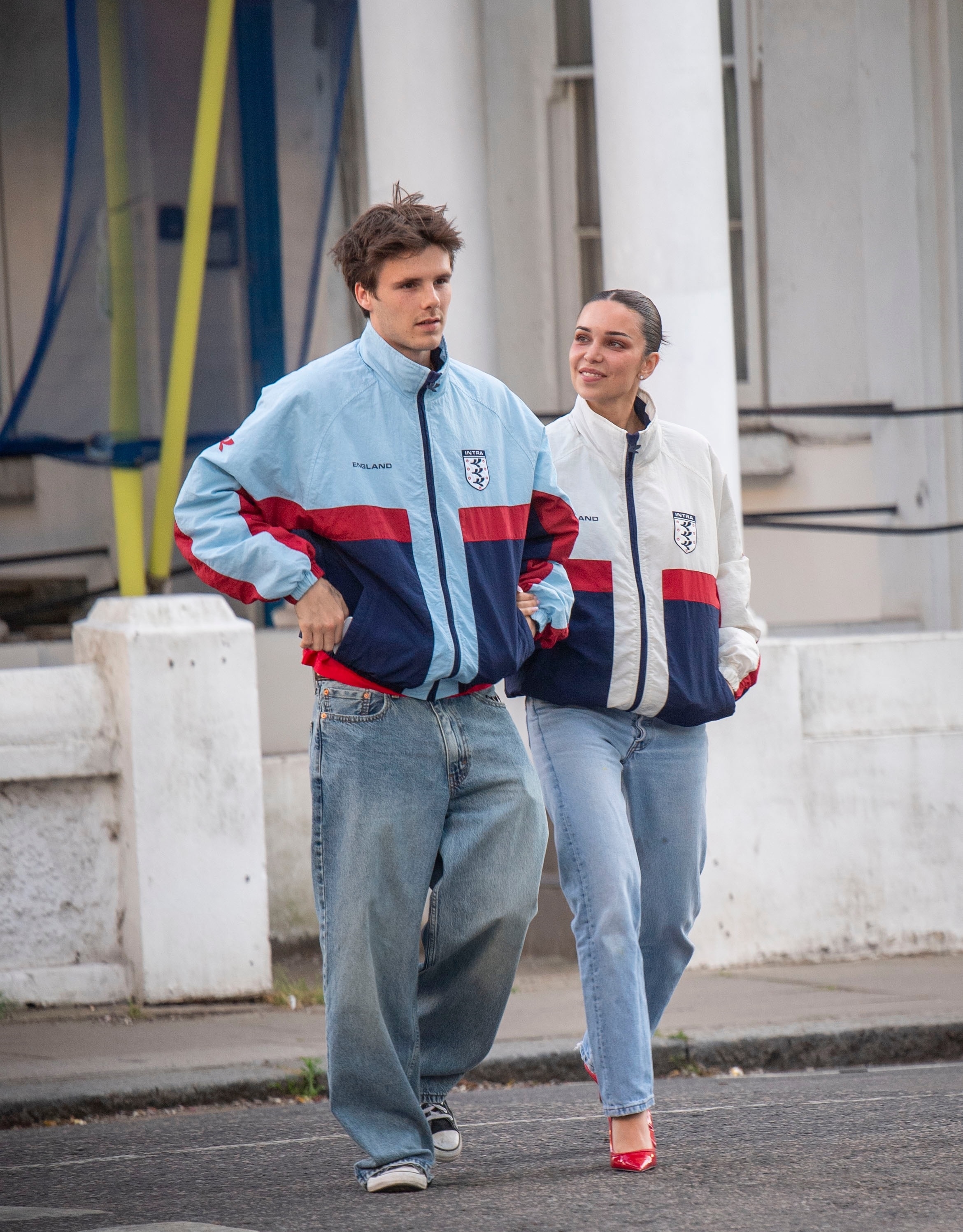 Cruz Beckham and Jackie Apostel in matching "England" jackets and jeans.