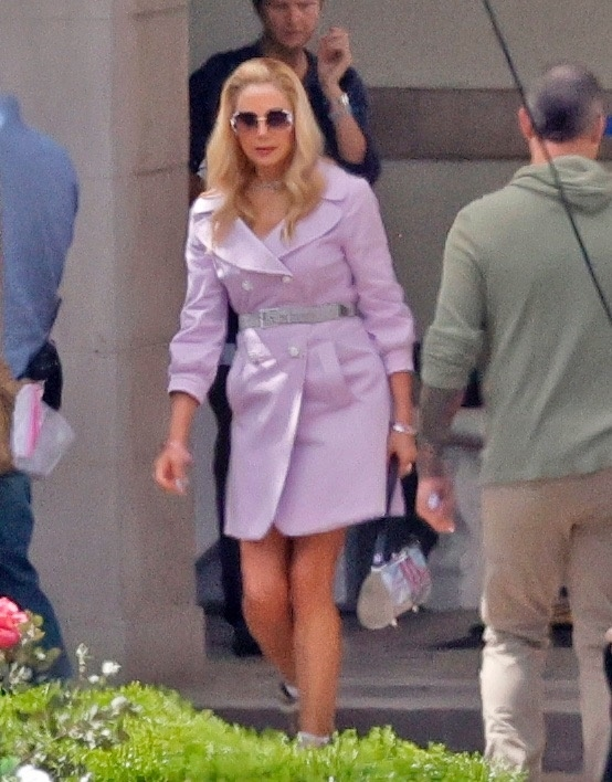 Mira Sorvino as Romy in a purple trench coat dress and sunglasses.