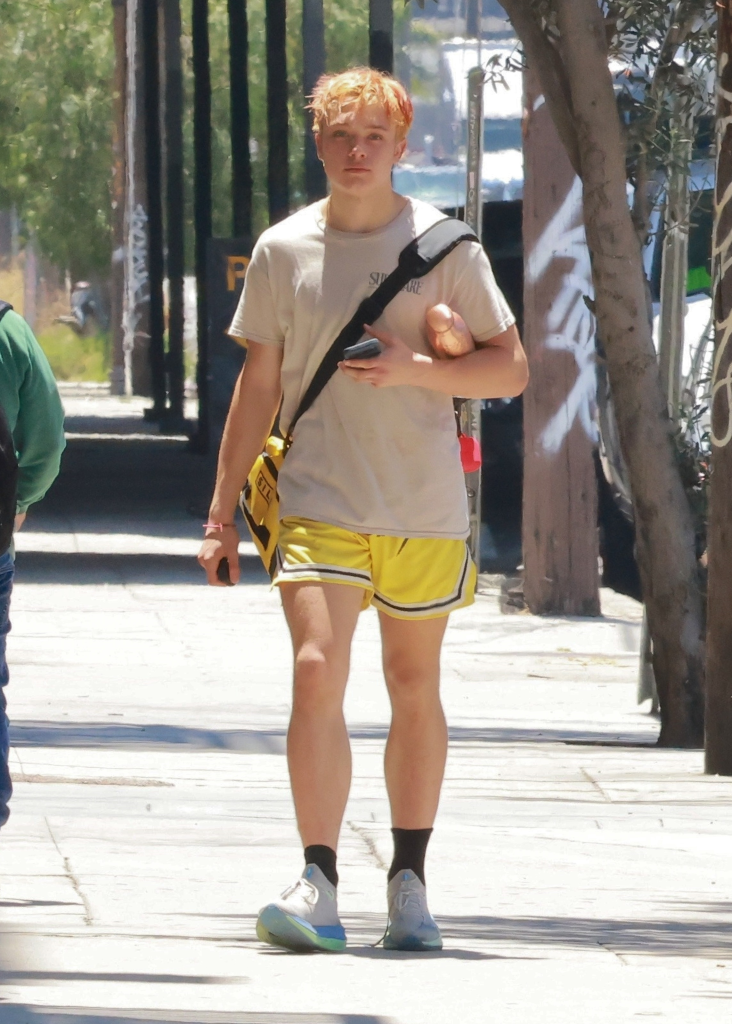 Knox Jolie-Pitt in athletic wear carrying a water bottle after a Muay Thai training session.