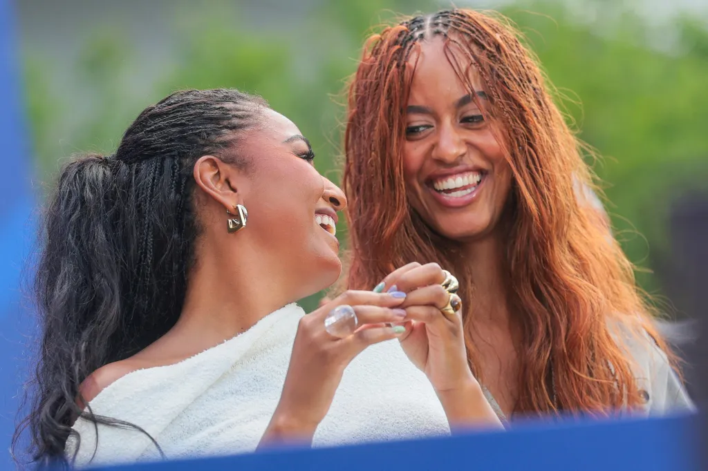 Sasha and Malia Obama laughing at the dedication ceremony for the opening of the Obama Presidential Center.