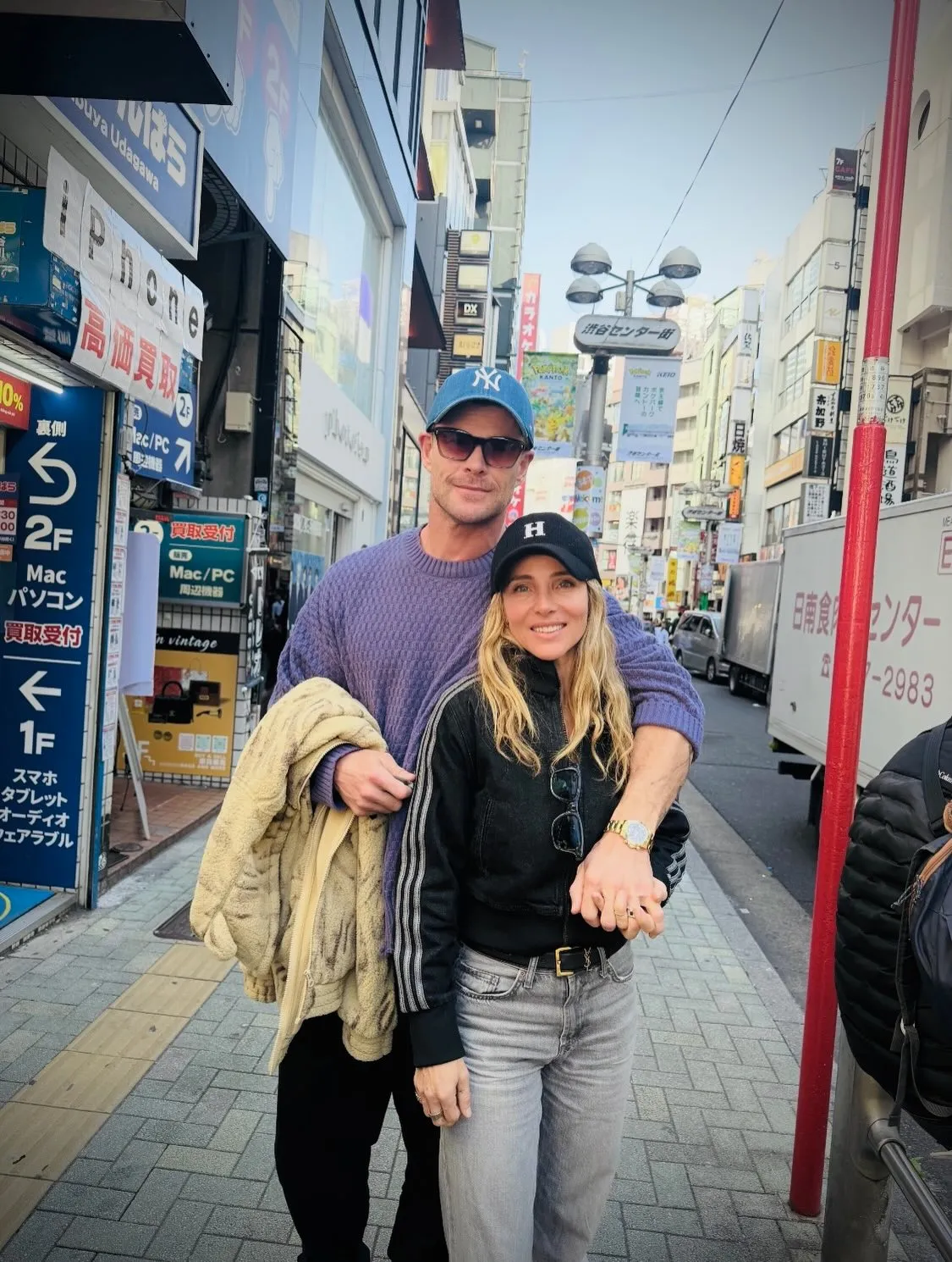 Chris Hemsworth and Elsa Pataky standing on a busy street in Japan.