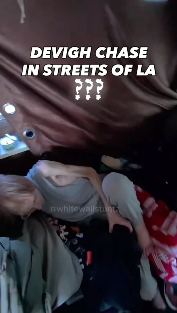 A woman, Devigh Chase, lying on the ground, likely on Skid Row in LA.