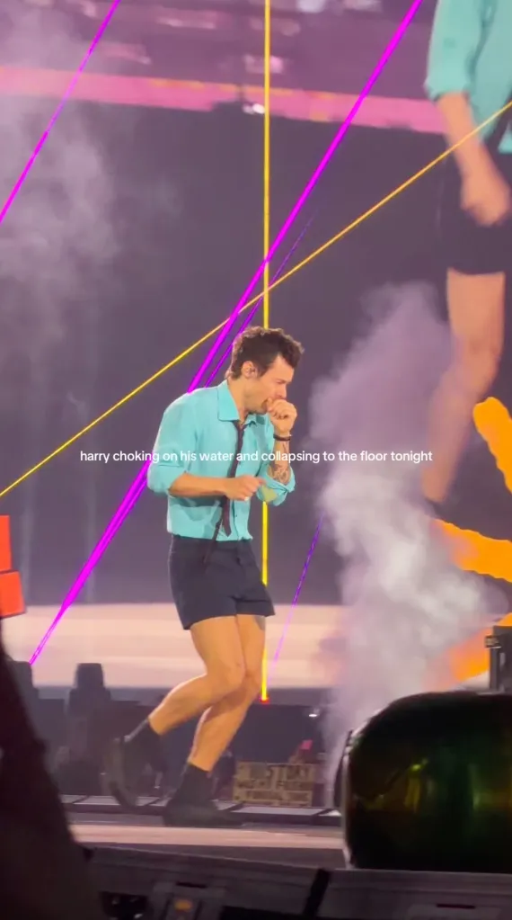 Harry Styles choking on water and collapsing on stage.