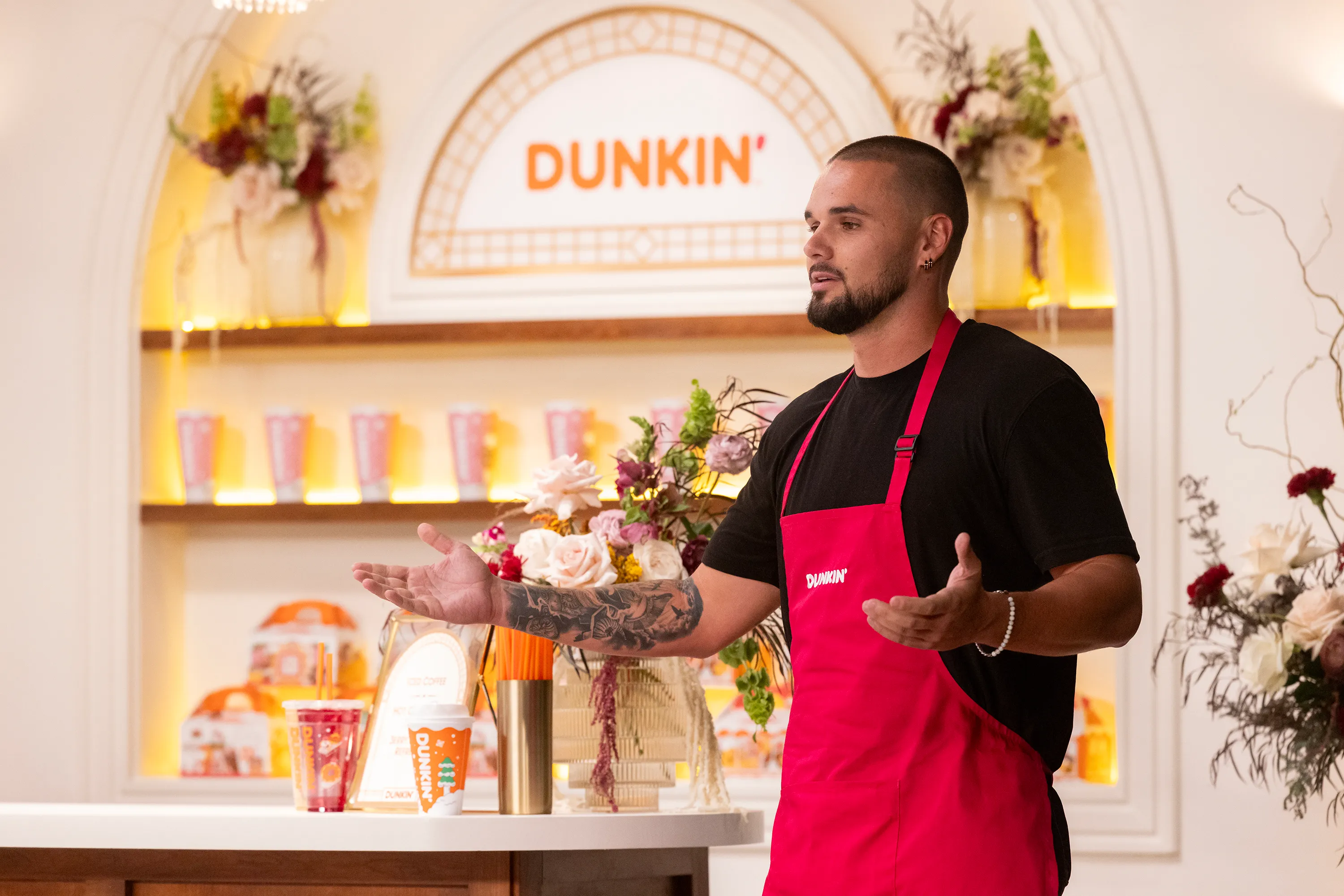 Chase McWhorter wearing a Dunkin' apron.