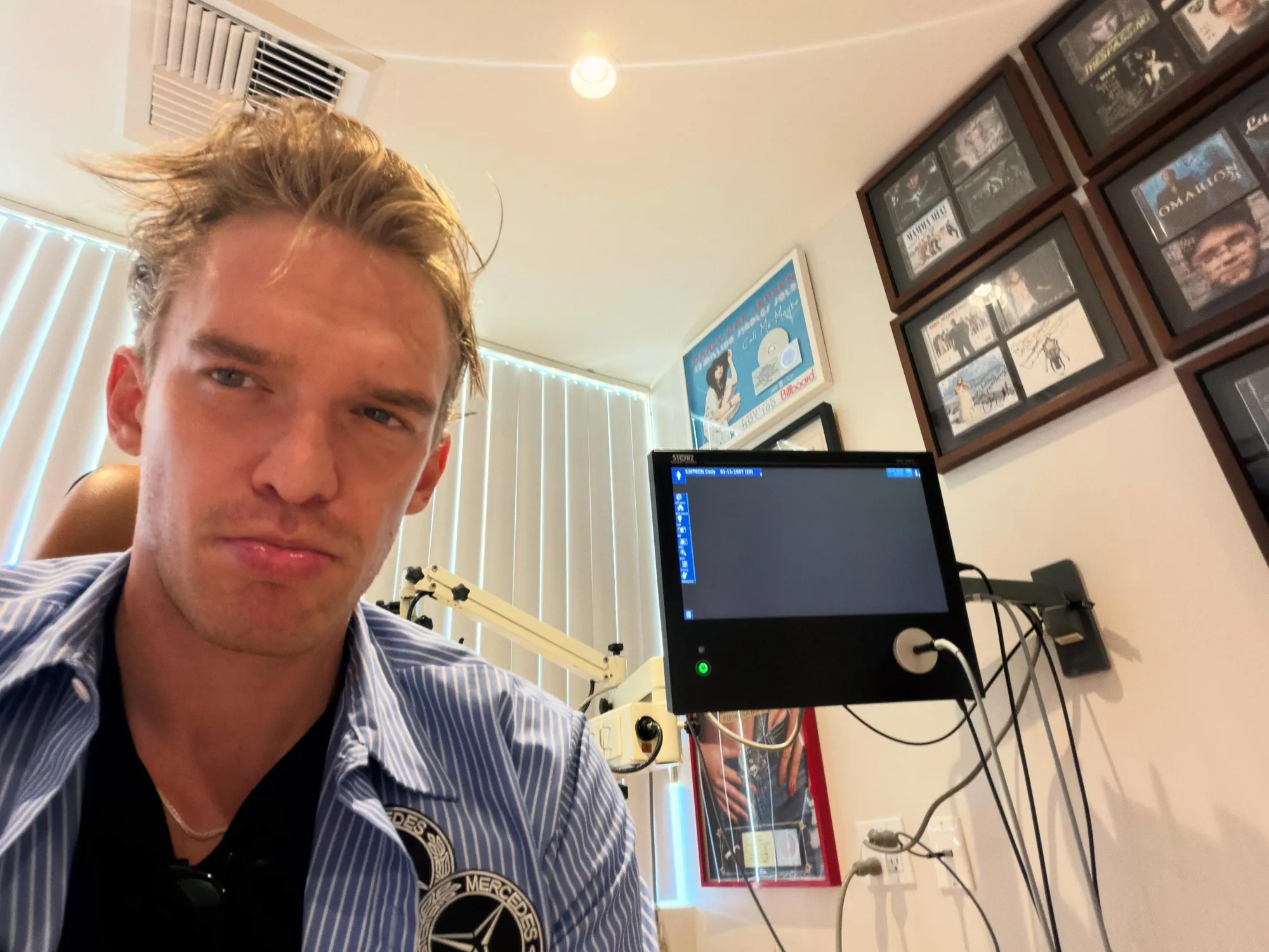 Cody Simpson in a doctor's office, looking directly at the camera.