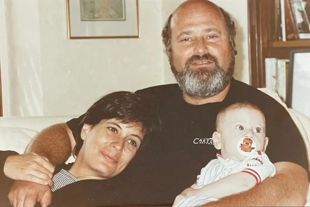 A man and woman, Michelle and Rob, with their baby.