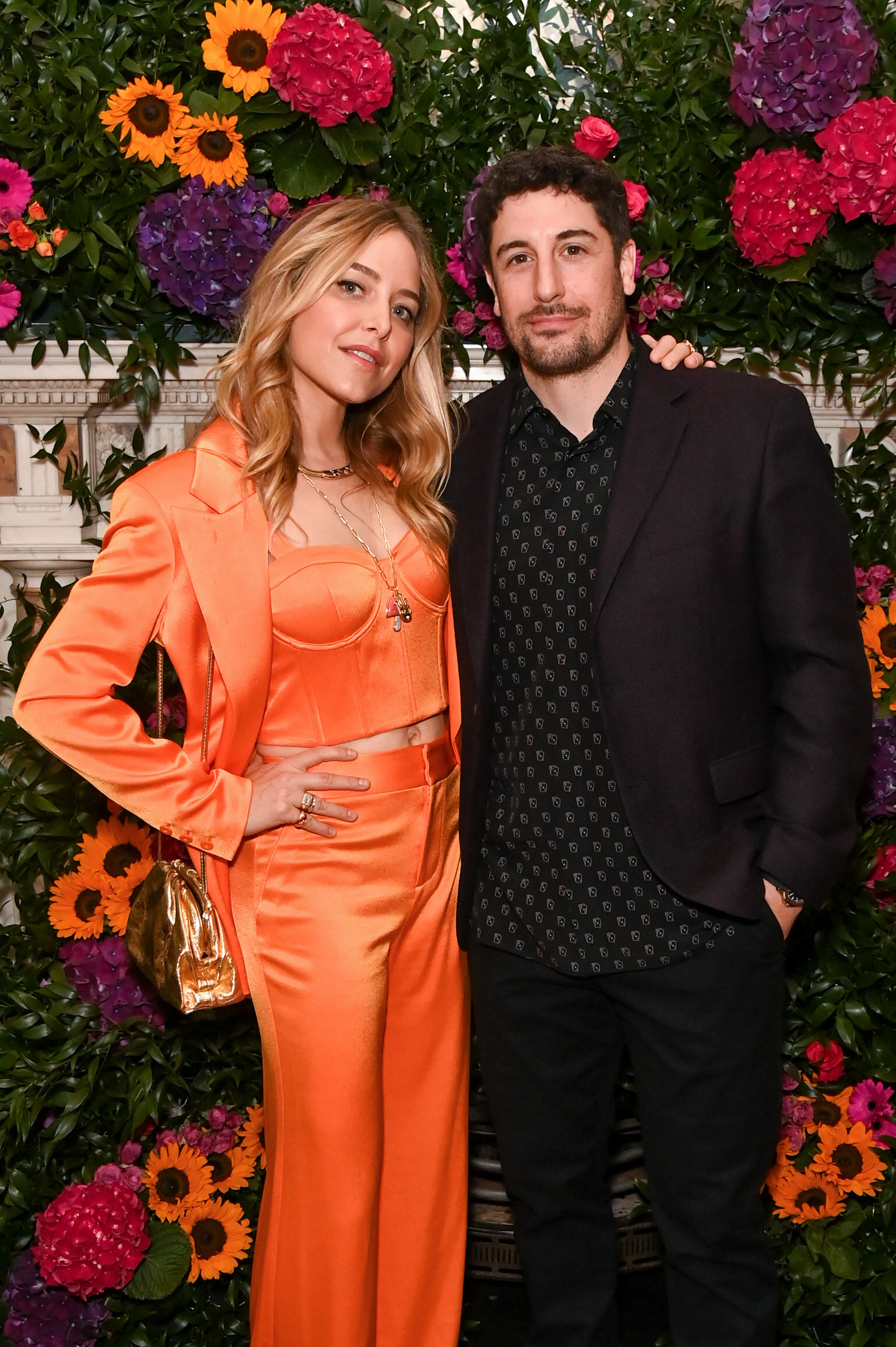 Jenny Mollen and Jason Biggs posing together at an event.