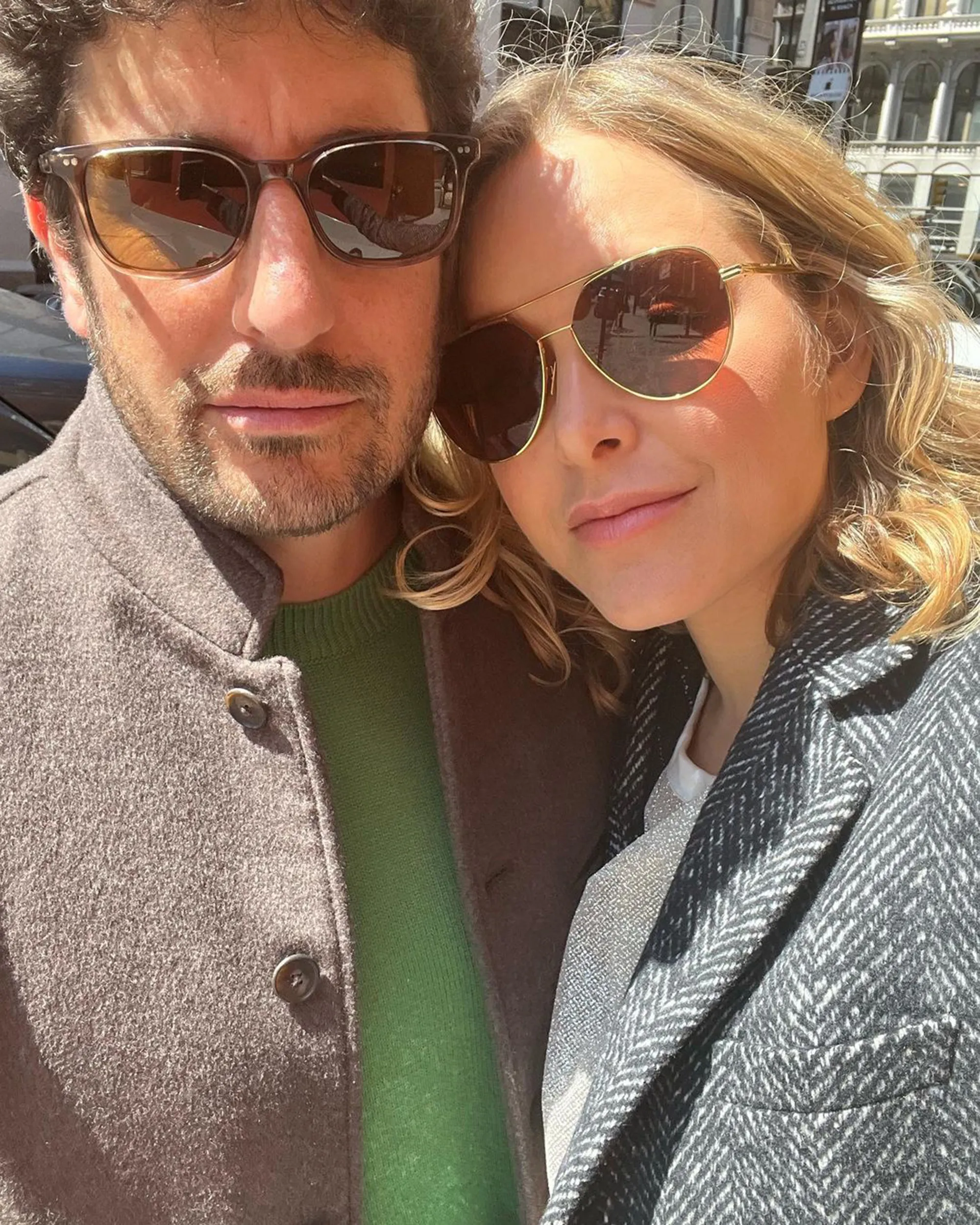 Jenny Mollen and Jason Biggs in sunglasses, posing closely together for a selfie.