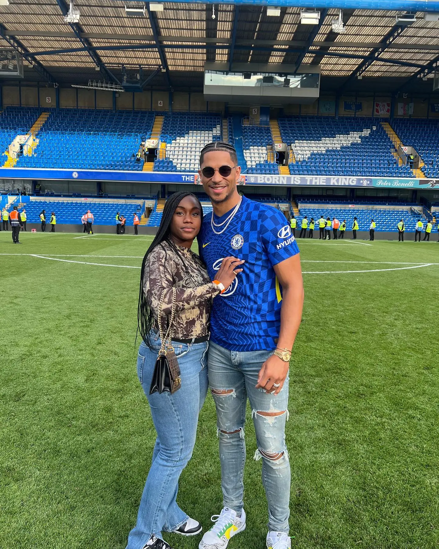 Shannon and Josh Hart on the field of a soccer stadium.