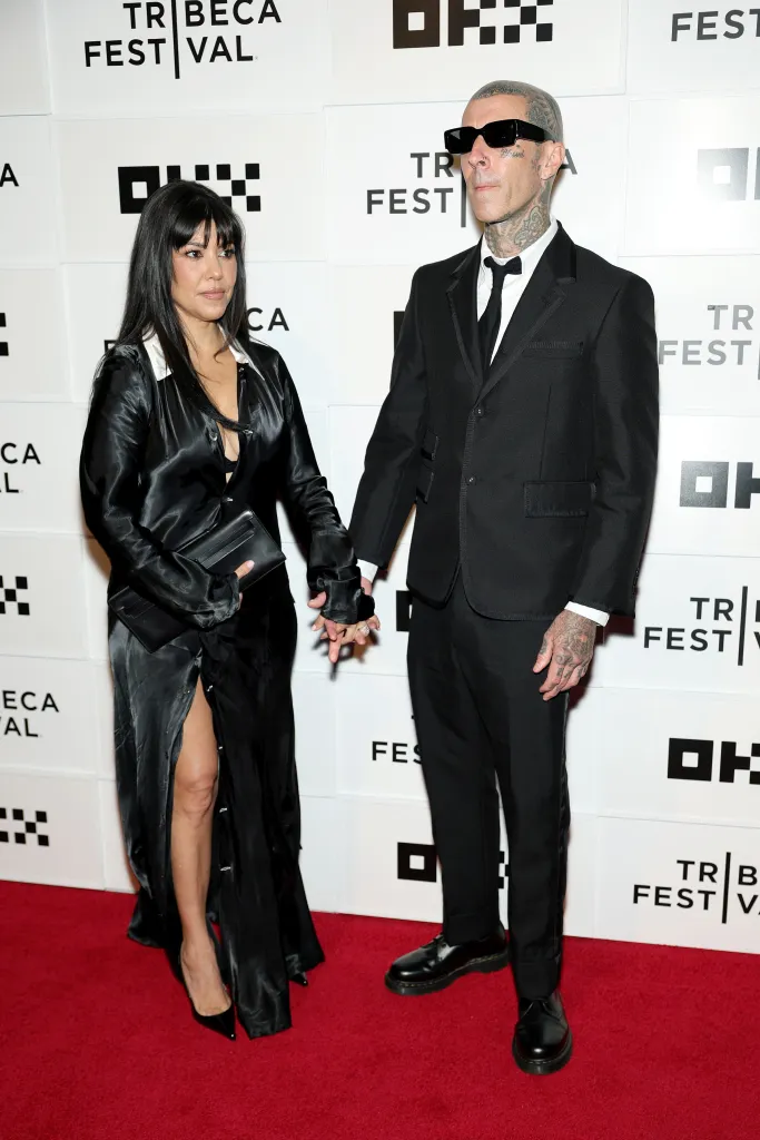 Kourtney Kardashian Barker and Travis Barker holding hands at the "Travis Barker: Louder Than Fear" premiere during the 2026 Tribeca Festival.