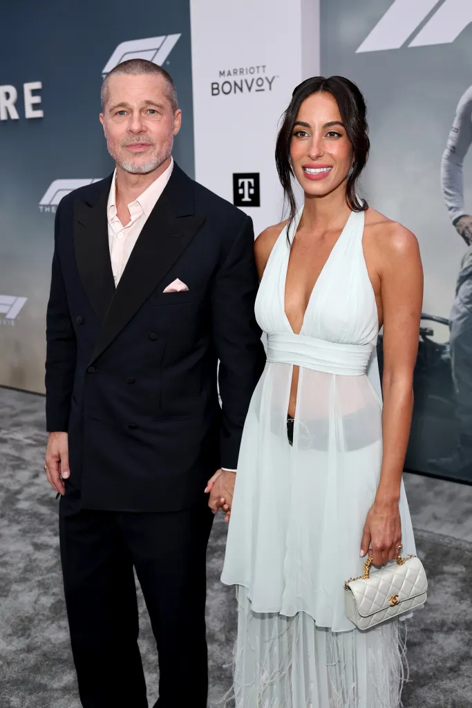 Brad Pitt and Ines de Ramon holding hands at the "F1® The Movie" premiere.