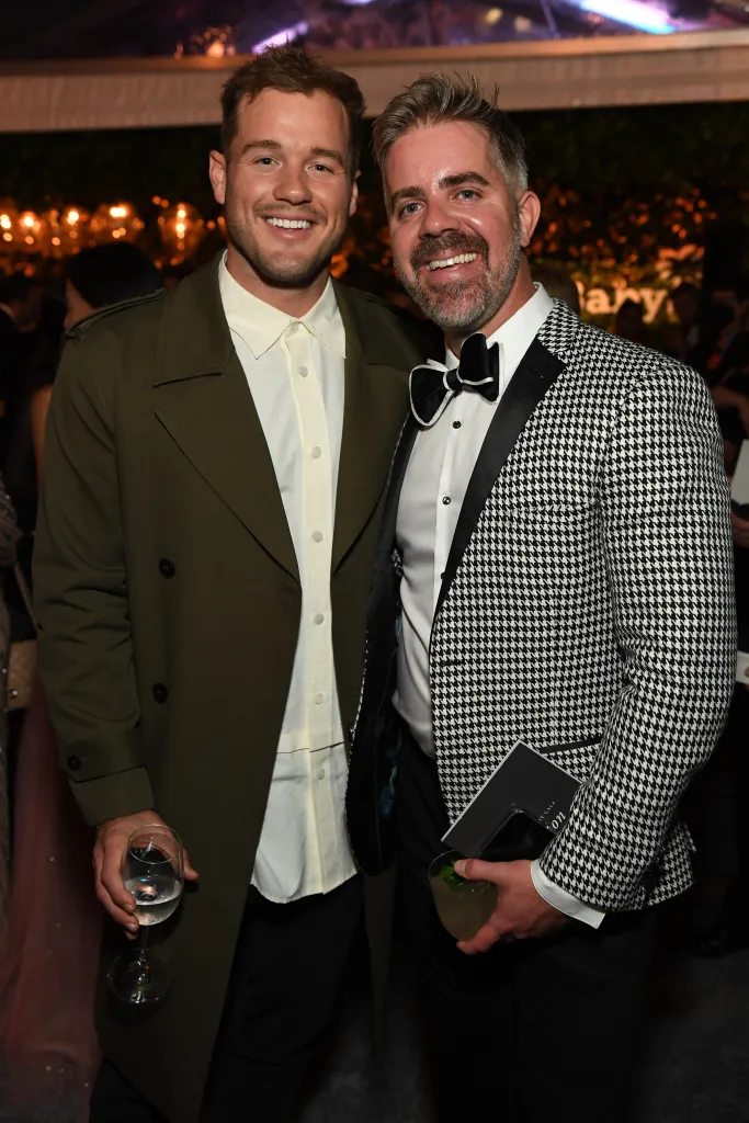Colton Underwood and Jordan C. Brown pose for a photo at an event.