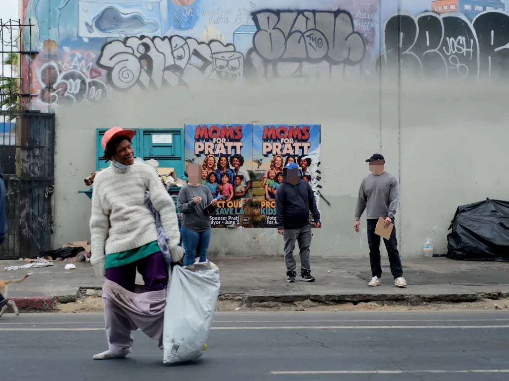 Plain-clothed FBI agents speak to people on 5th and Towne Ave. in Los Angeles' Skid Row.
