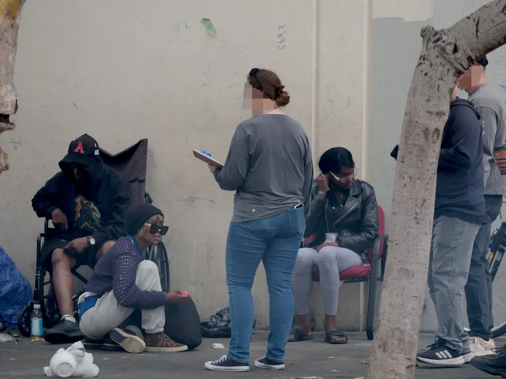 FBI agents speak to homeless people on Skid Row regarding voter fraud.