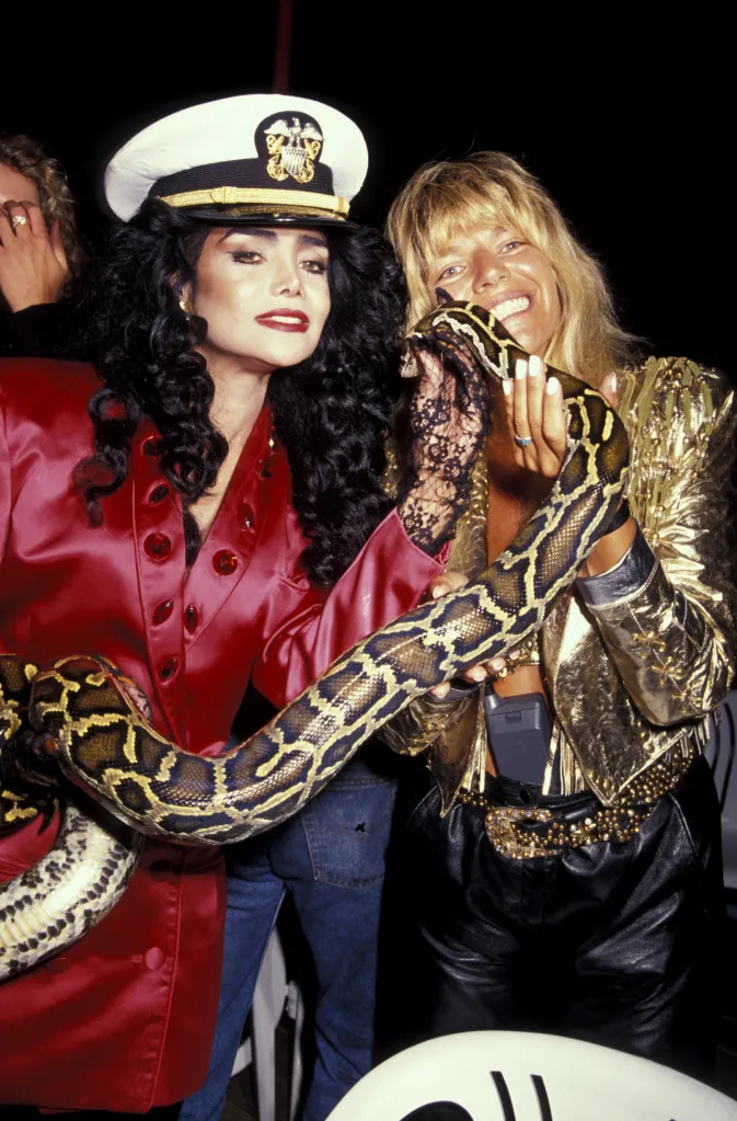 LaToya Jackson and Robin Byrd holding a snake at Kim Hunter's Birthday Party.